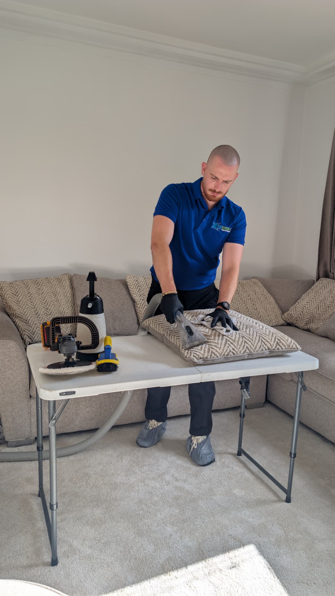 Sealstone technician cleaning upholstery at a work table in Staffordshire