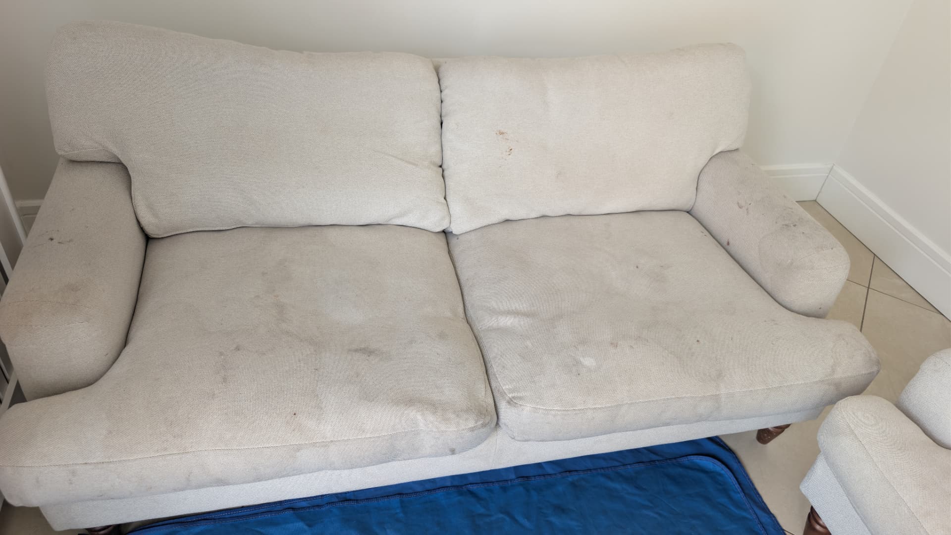 White fabric sofa cleaned in Staffordshire, before professional cleaning