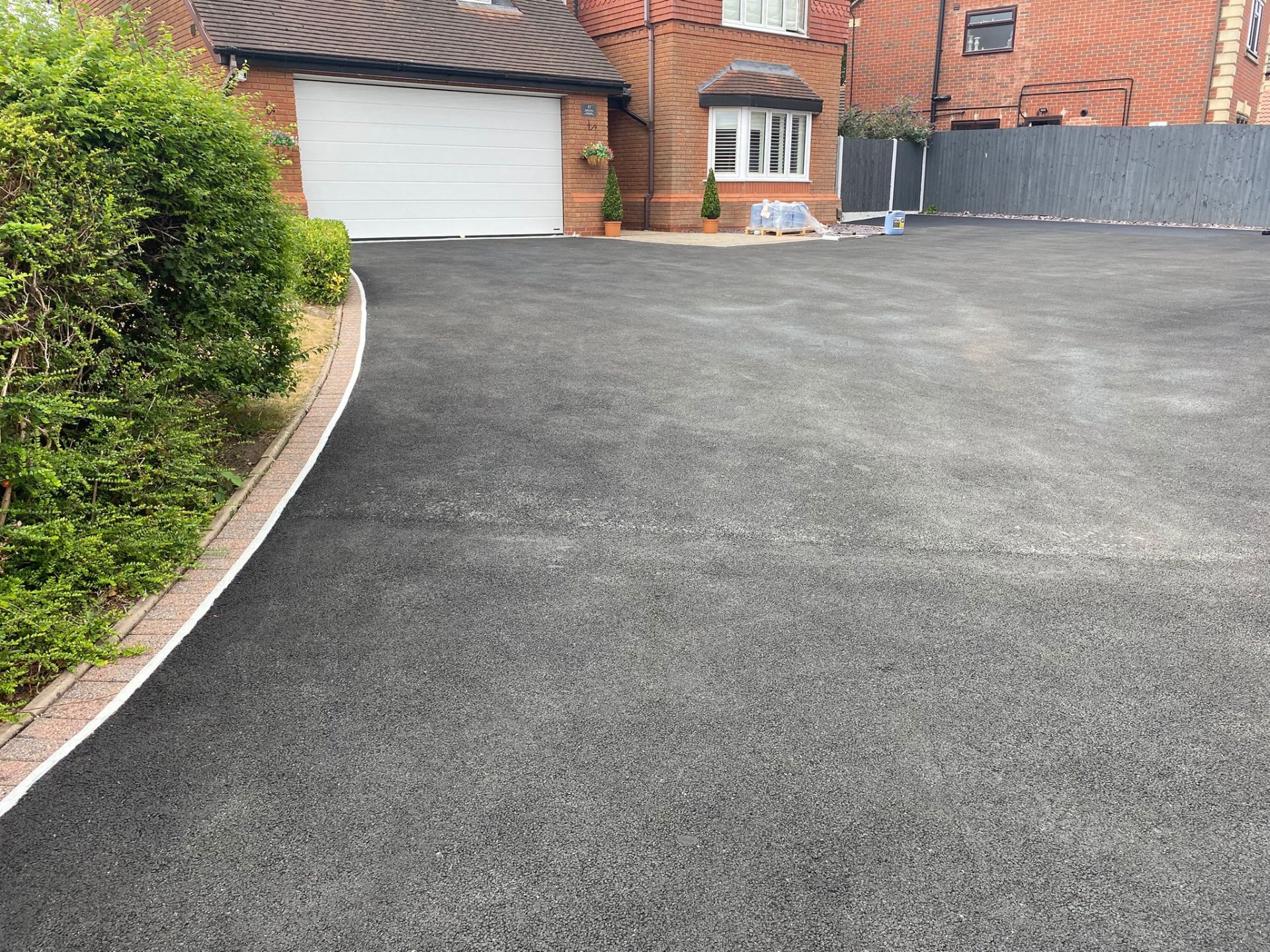 Faded grey tarmac driveway before recolouring in Staffordshire